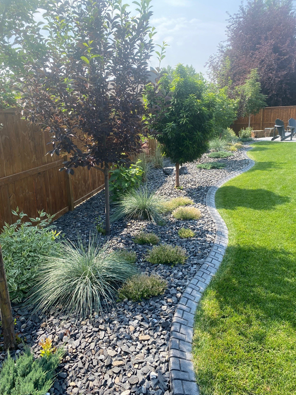 concrete edge around nice landscaped flower beds
